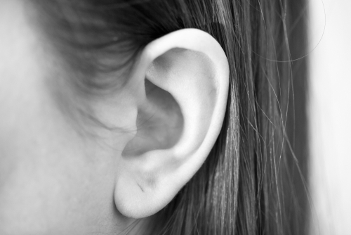 Model Womans ear from close perspective for otoplasty procedure