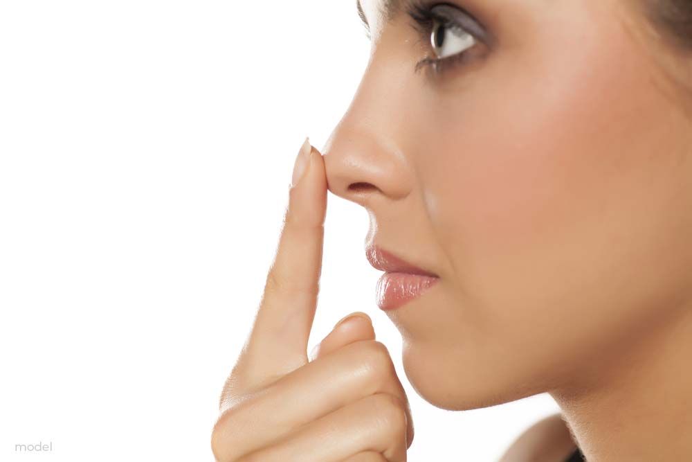 Woman touching the tip of her nose