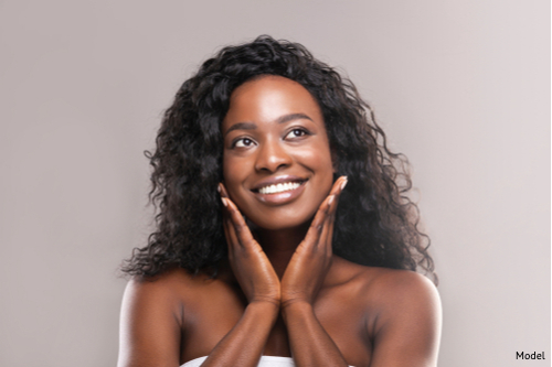 Woman enjoying the results of a full and smooth face after treatment.