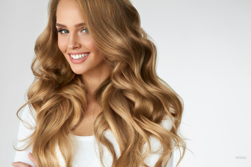 Young woman with long, thick, healthy, wavy hair.