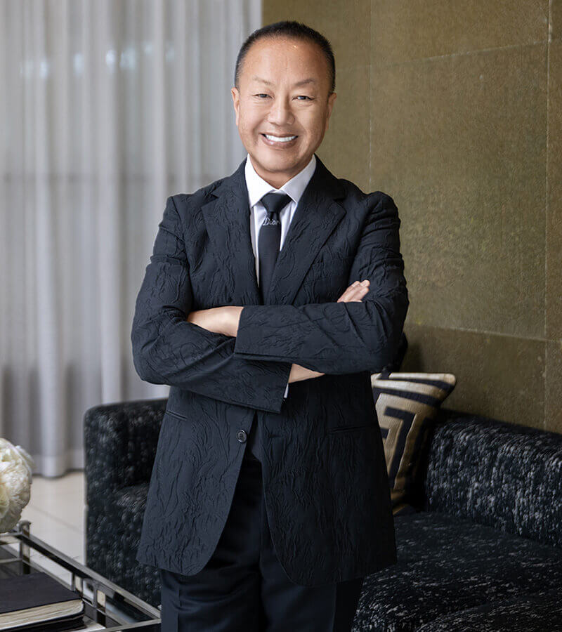 Dr. Chiu in a suit with his arms crossed