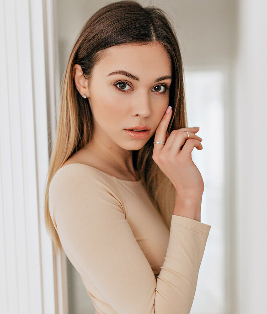 Young woman touching her face
