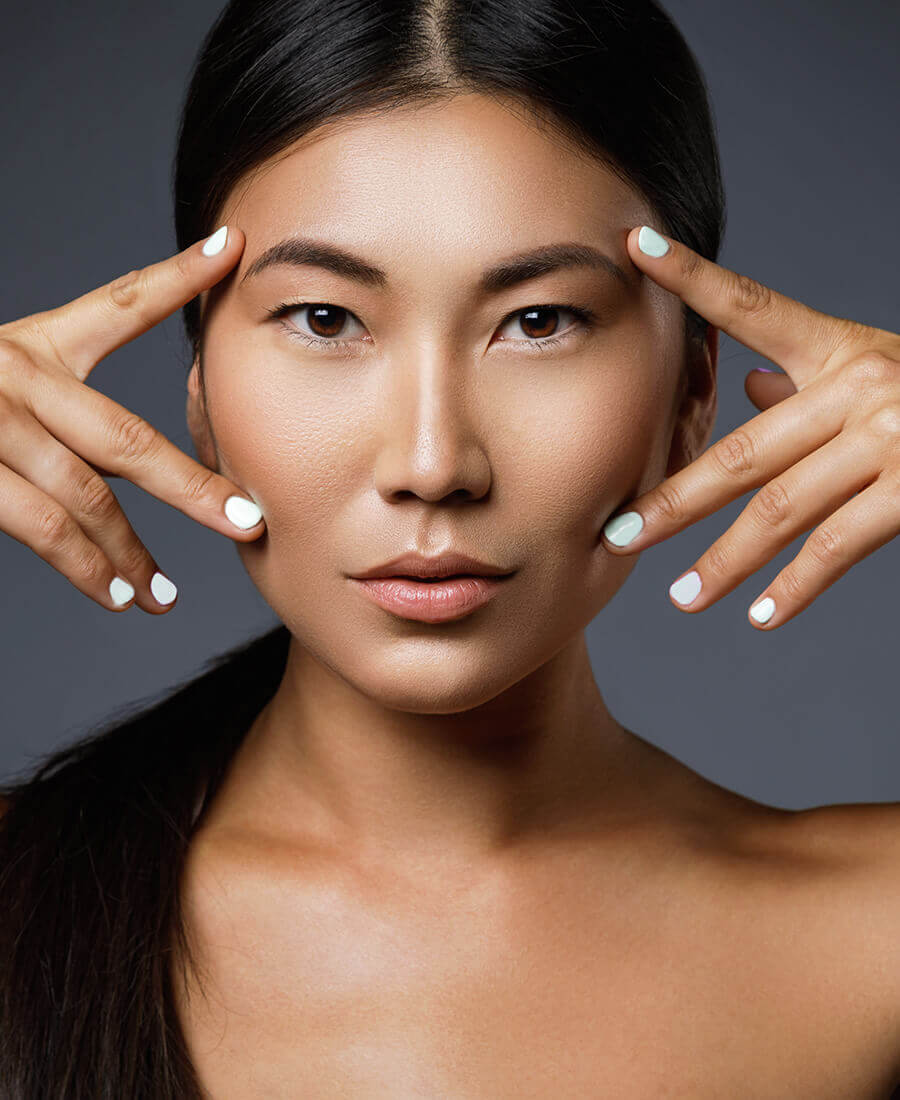 Woman framing her eyes with her hands