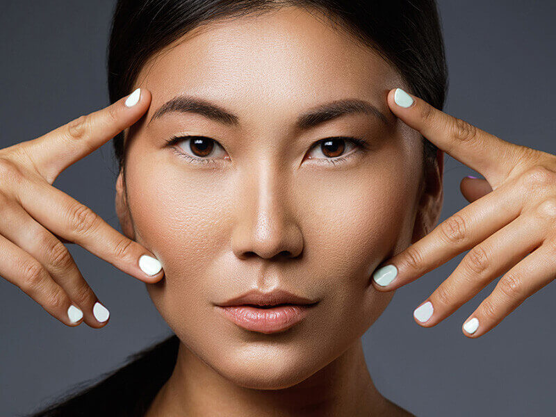 Woman framing her eyes with her hands