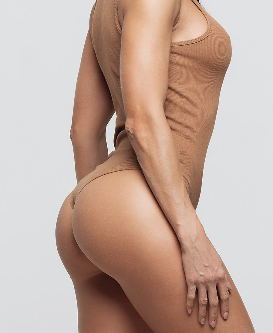 Woman in a tan one piece bathing suit
