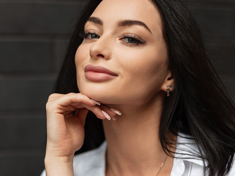 Woman with her hand under her chin