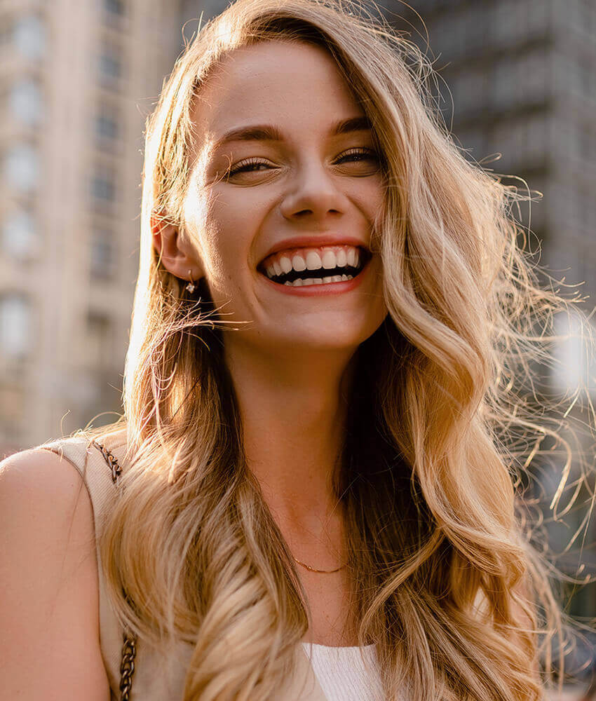 Woman in a city, smiling