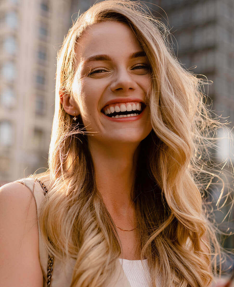 A blonde woman smiling