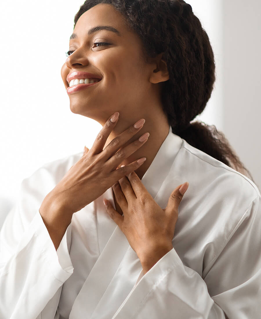 Woman with braided hair touching her neck