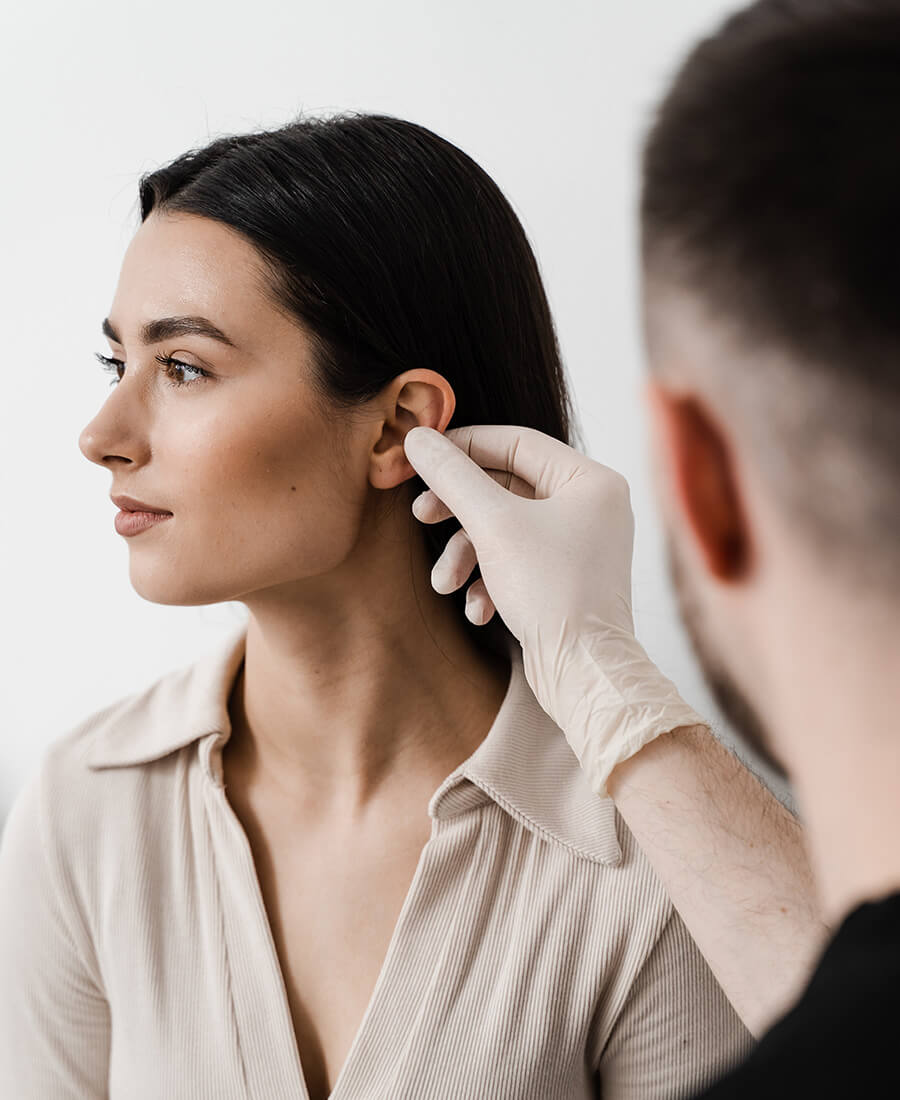 A woman getting her ear examed