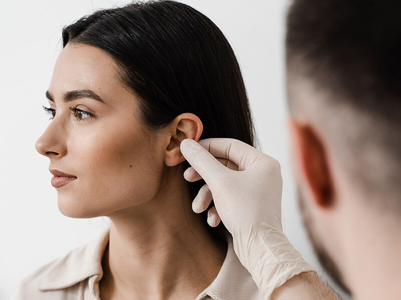 Woman having her ears inspected