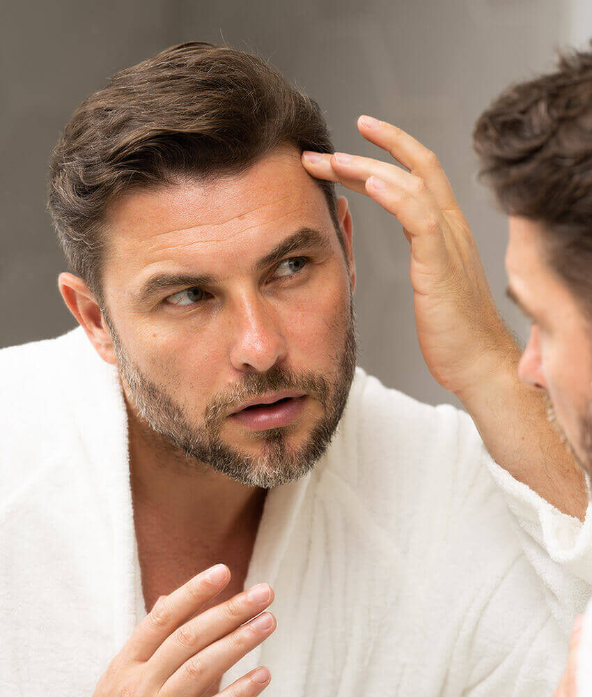 Man looking at himself in the mirror
