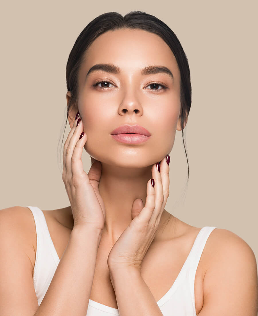 Young woman touching her face
