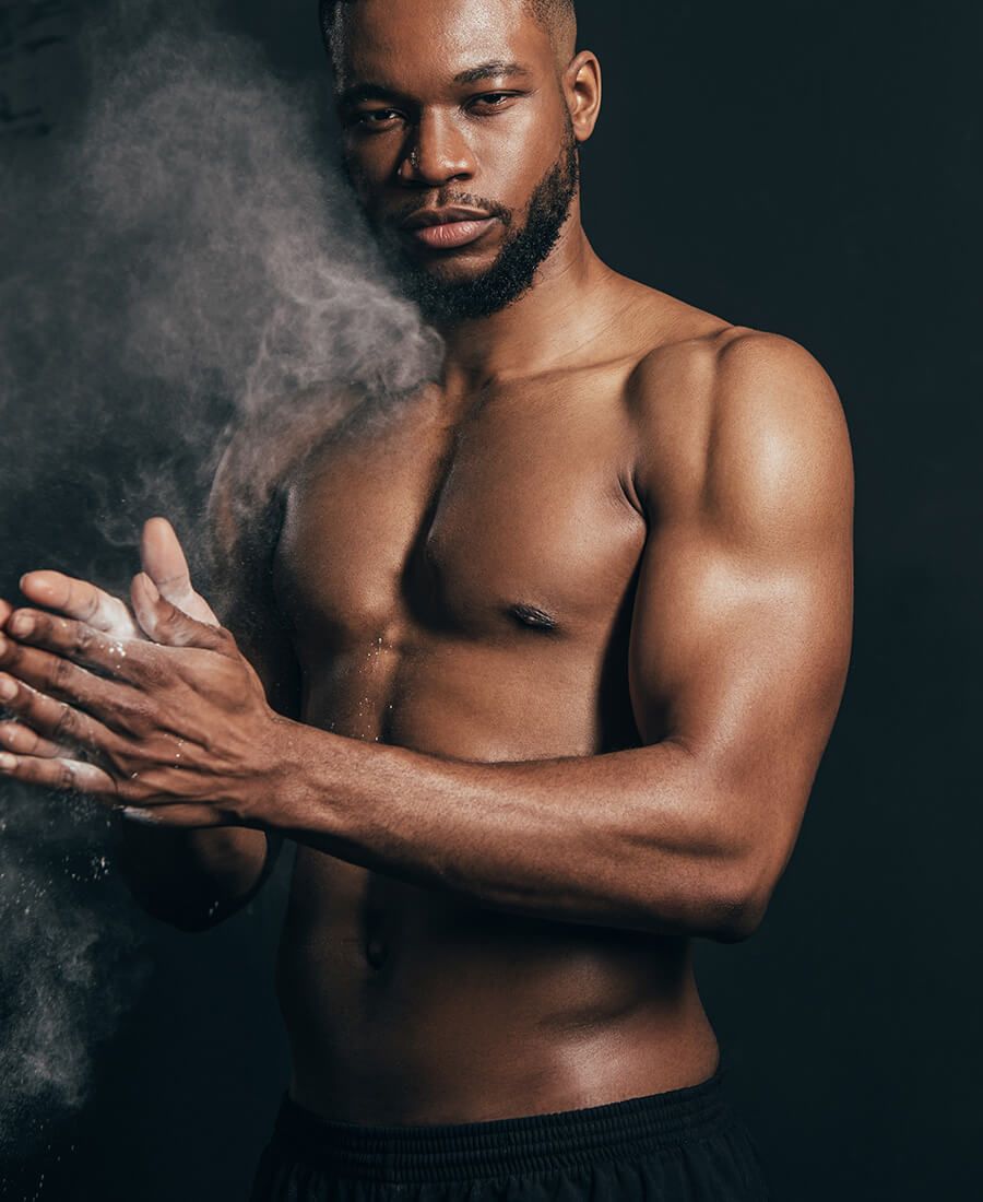 Fit man with chalk on his hands