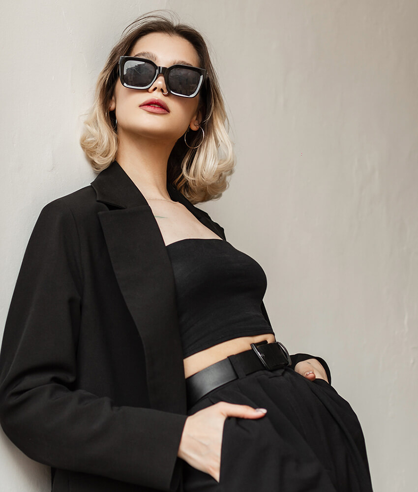 Woman in black with her hands in her pocket