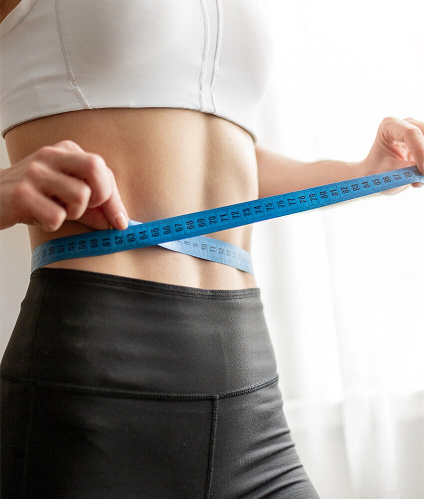 Woman measuring her stomach