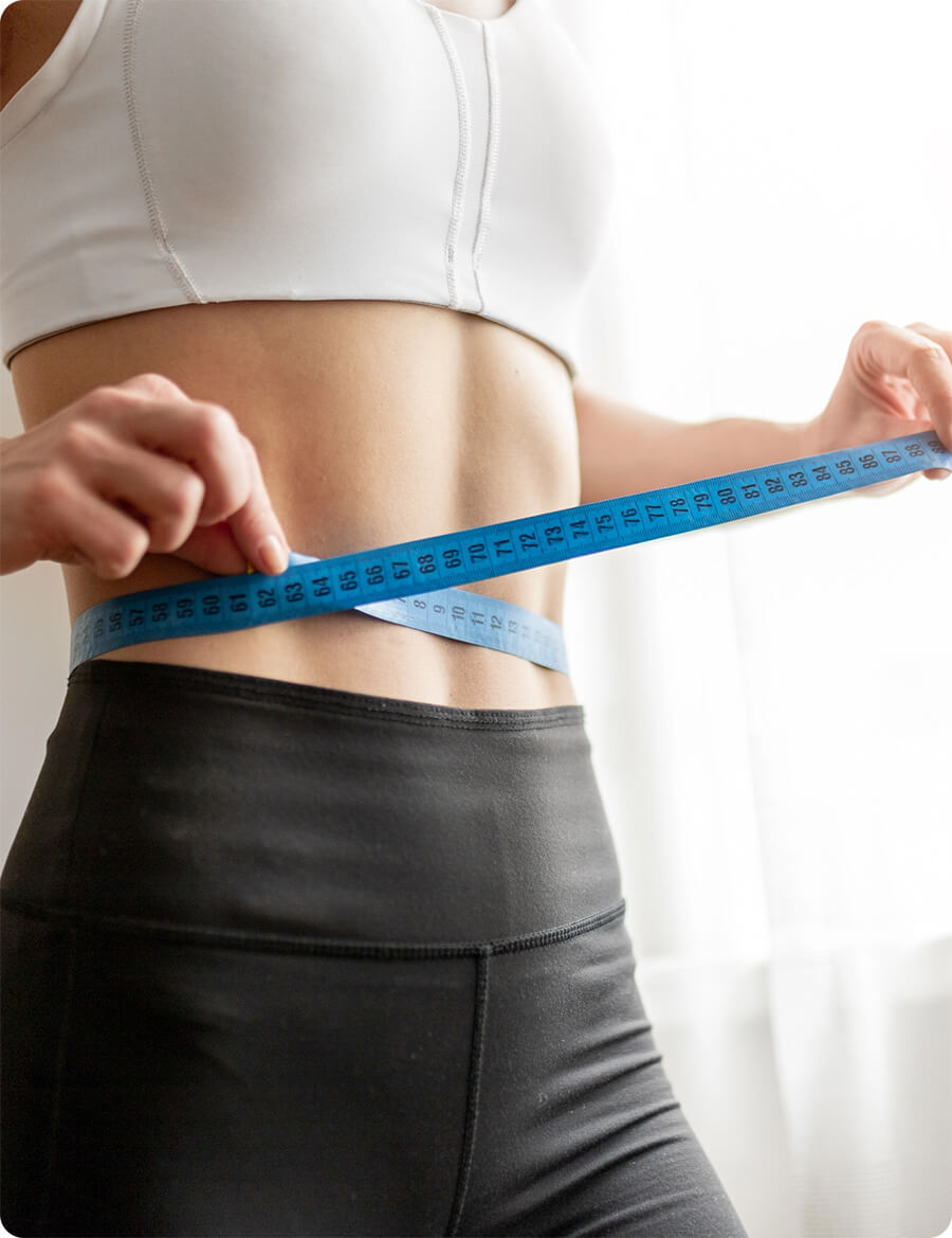 Woman measuring her belly