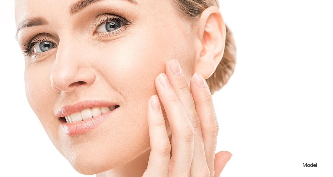 woman touching her face