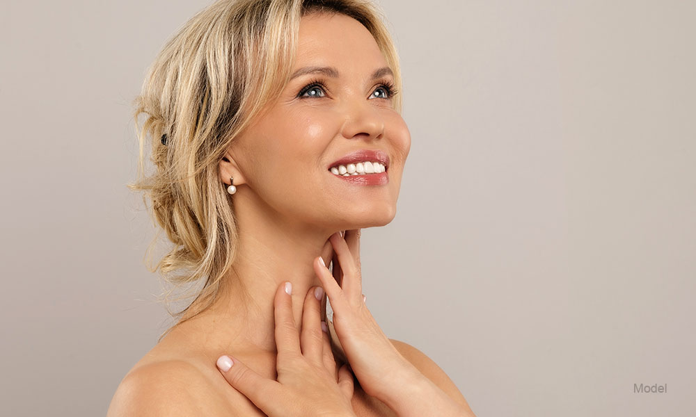 Mature woman touching her neck