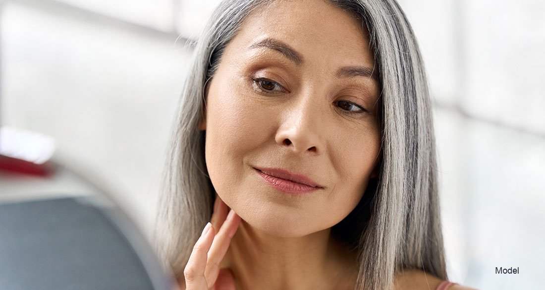 mature woman touching her face