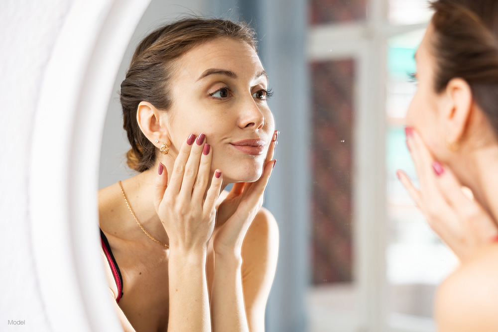 Woman looking at herself in the mirror