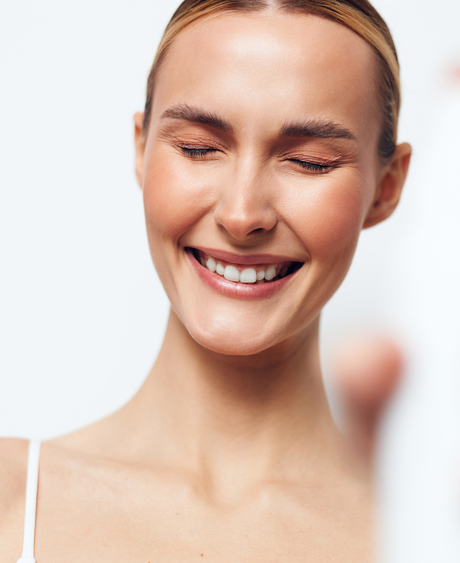 Mature woman smiling with her eyes closed